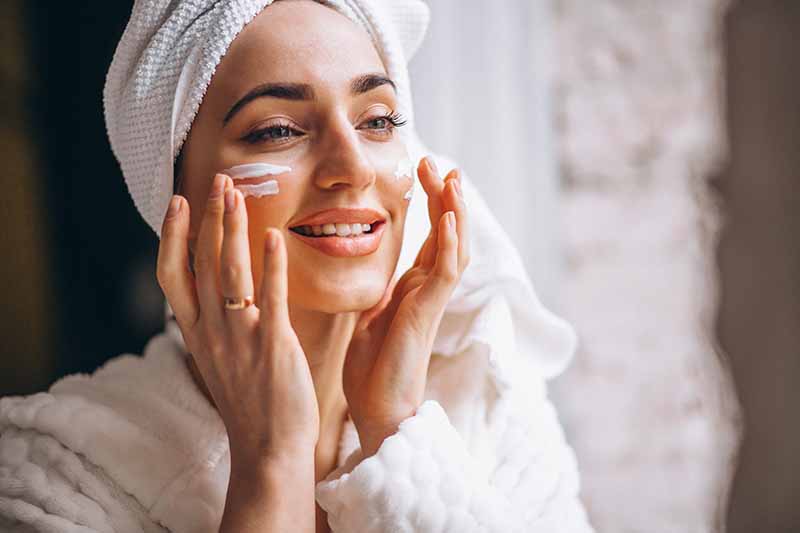 Woman applying face cream-skinpride